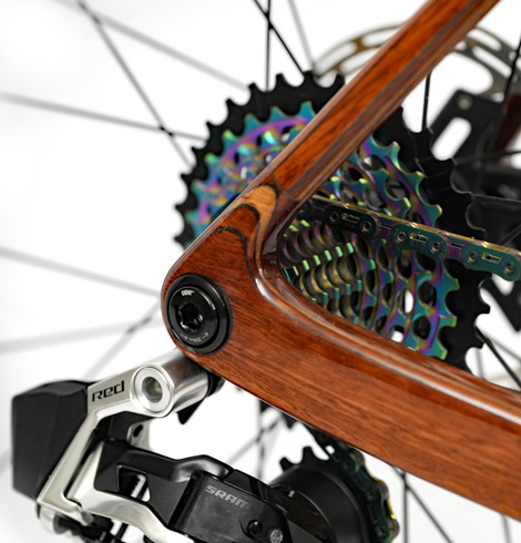 Closeup of HTech Aeriform laminated dropout with RHD core, UDH hanger, and rainbow cassette and chain