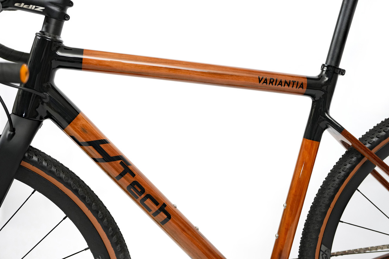 Main frame triangle of HTech Variantia gravel bike, recycled Karri wood with black painted carbon fiber lugs
